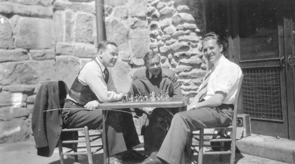 Three male German incarcerees playing chess at Assembly Inn.
